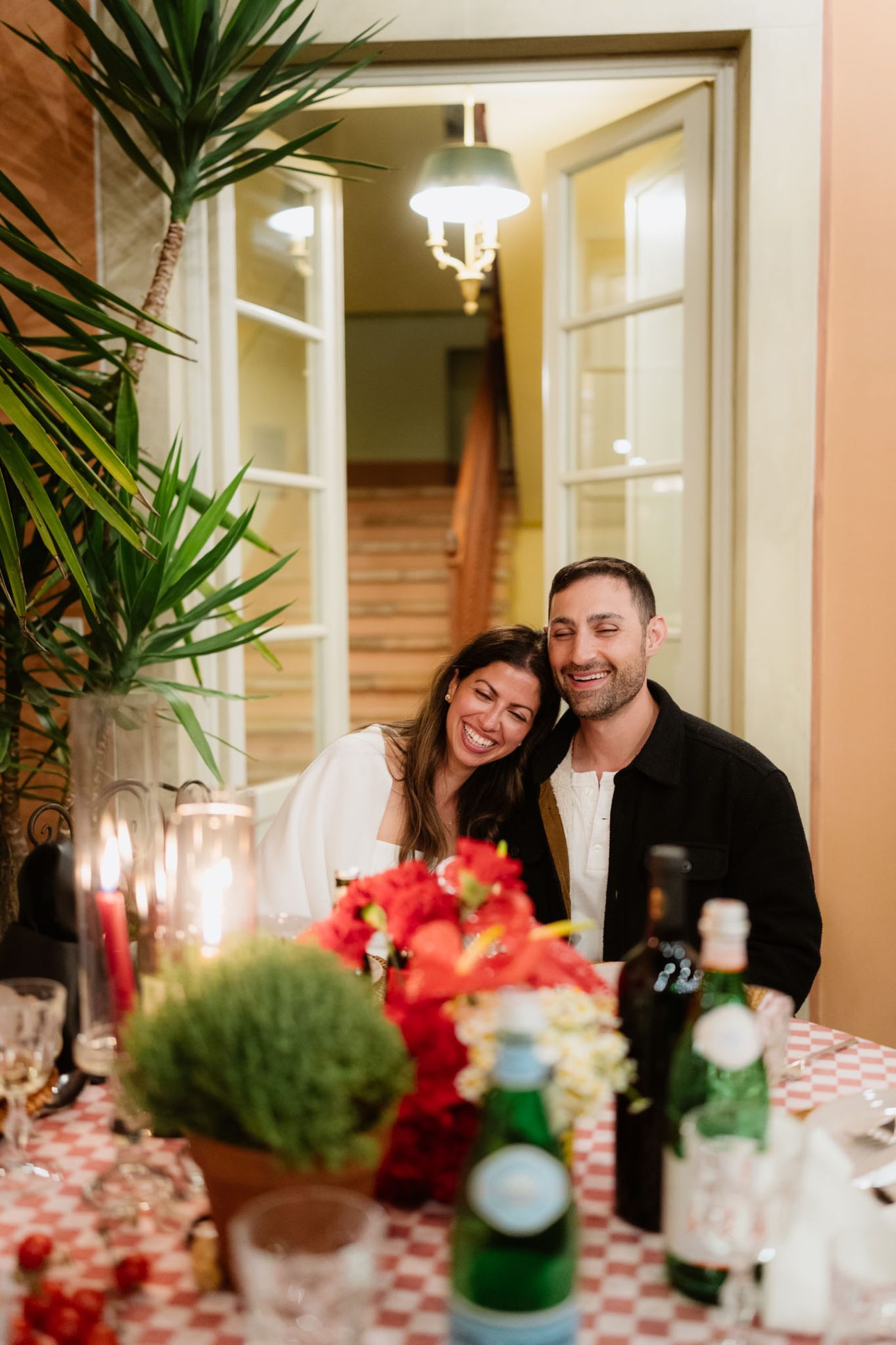 Emily & Refael sharing an intimate moment during Pizza Party Tuscany
