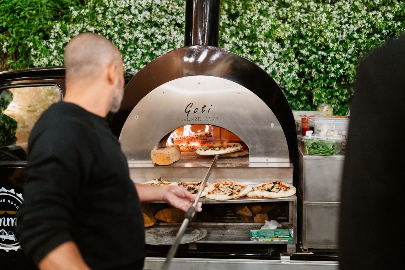 Fresh pizza from wood-fired oven at Tuscany destination wedding