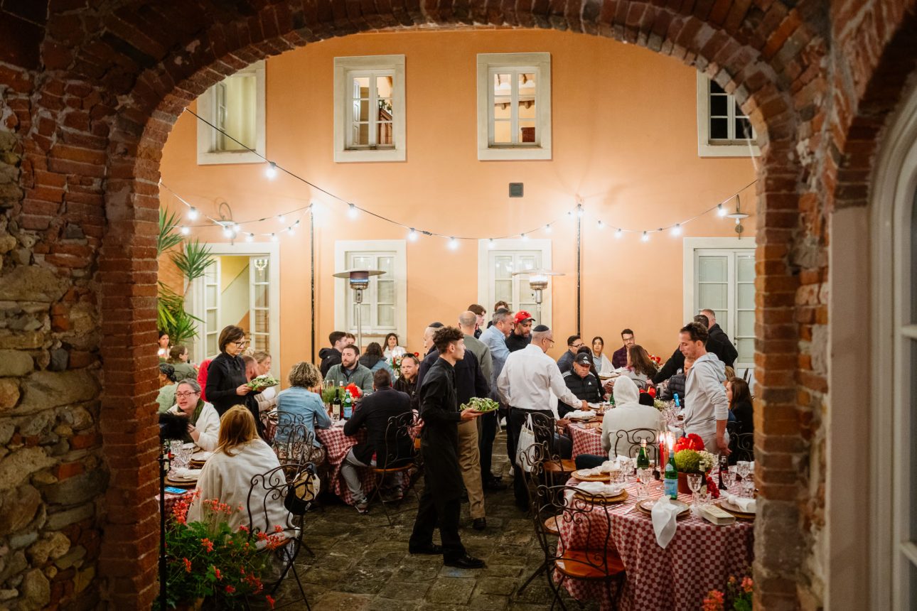 Friends and family gathered at long tables Villa Lenka Tuscany