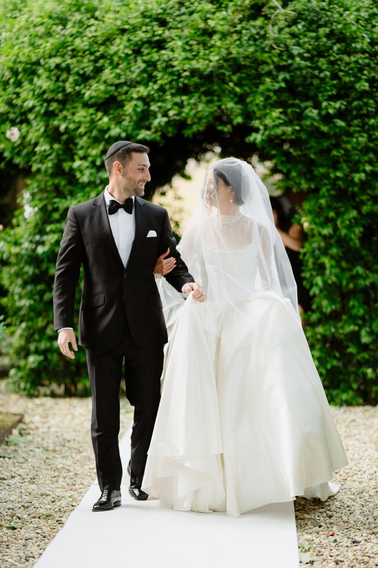Bride and groom walking down aisle Tuscany