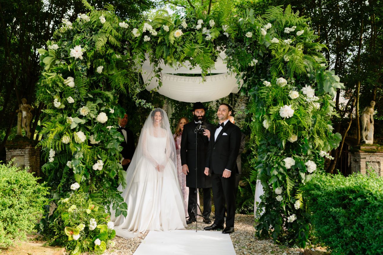 Rabbi leading ceremony under chuppah