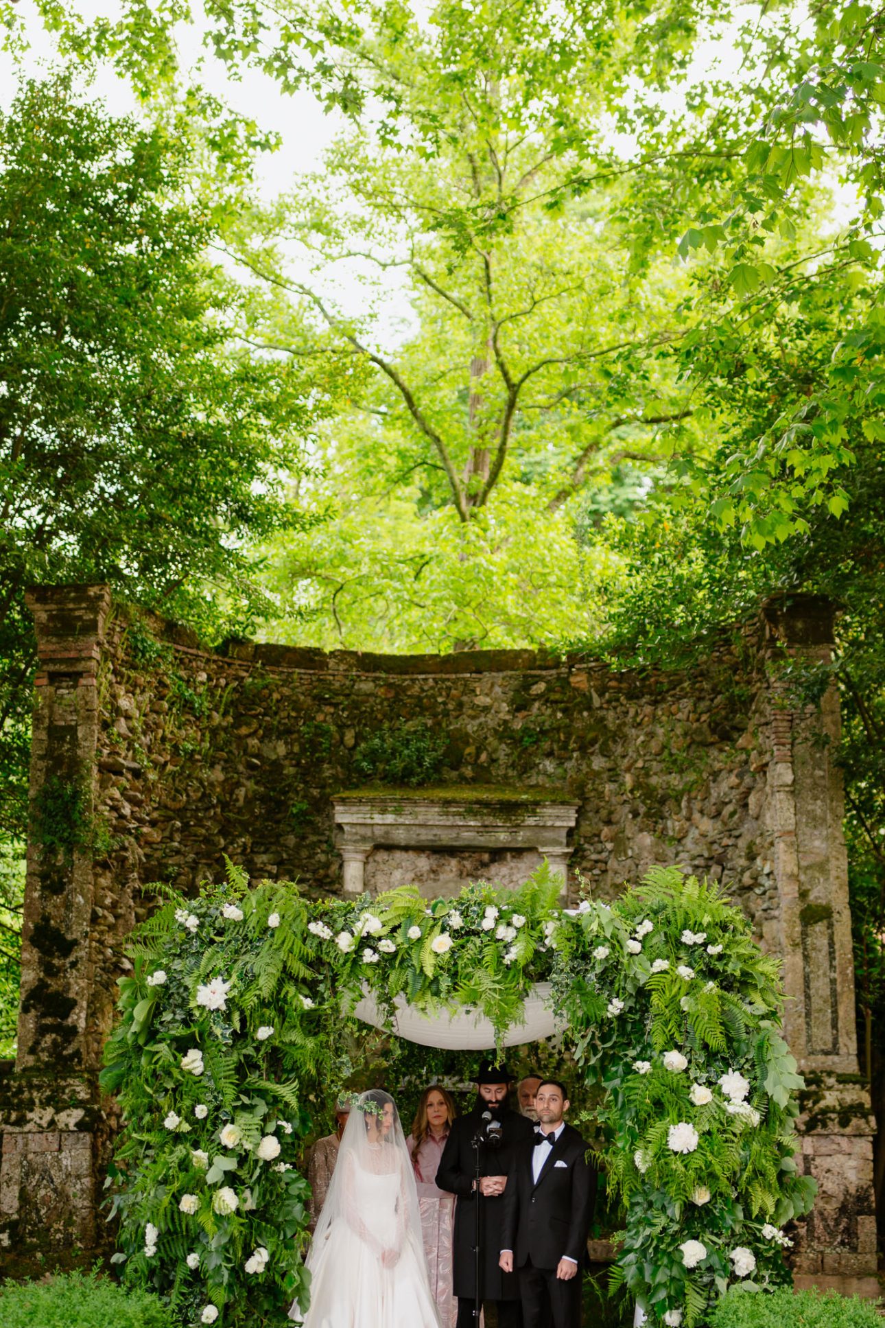 Ceremony decor with Tuscan backdrop