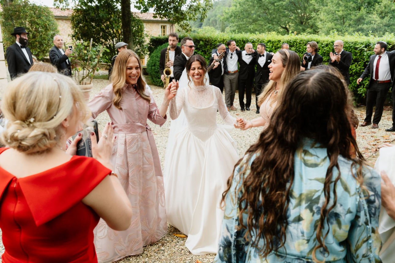 Emily and Refael celebrating after Jewish ceremony
